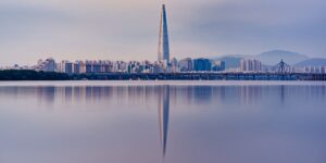 Skyscraper reflected in water.