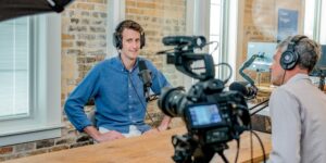 Person being interviewed with camera and microphone